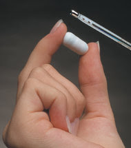 The CorTemp pill, from HQ Inc., has a built-in battery and wirelessly transmits real-time body temperature.