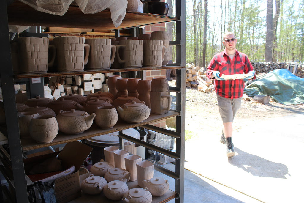 Chris loading pots into the kiln.