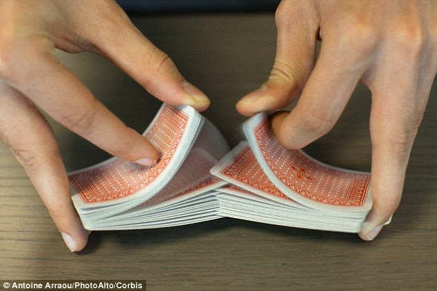 Peri Diaconis compared different shuffling techniques and said the 'riffle' shuffle (pictured), which involves cutting a deck in half and shuffling the halves into each other, is the most effective and random if done well