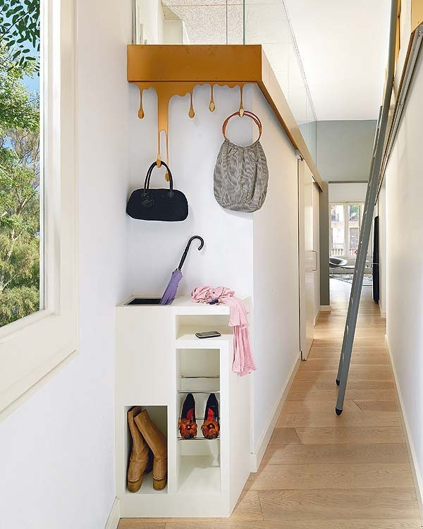 Purses hang from what seem to be dripping parts of the wood panel installed into the wall, another Gaudi-like feature.