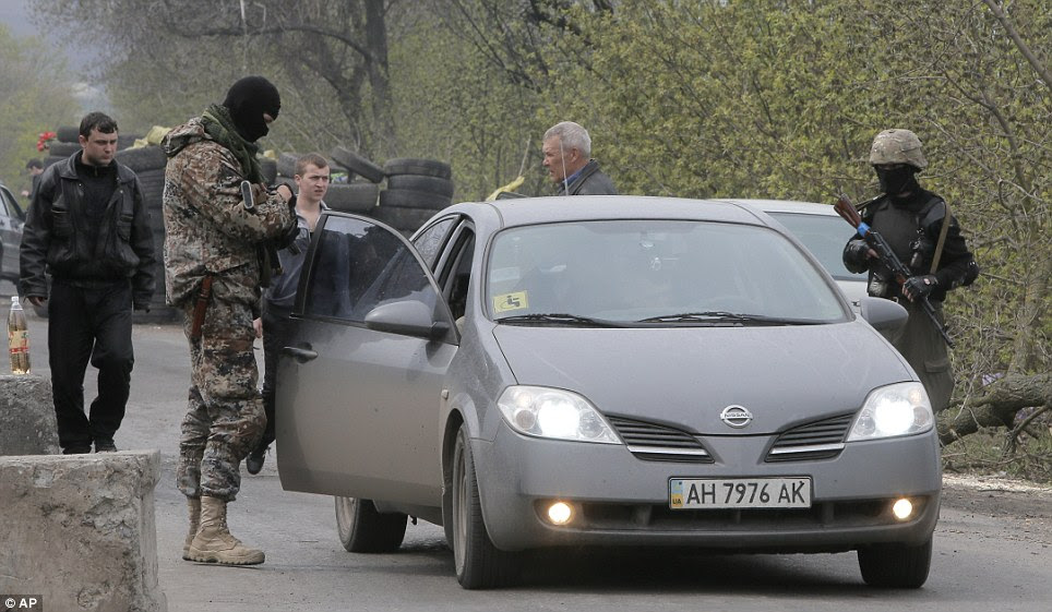 Pro-Russian gunmen at the check point which is under the control of pro-Russian activists in the village of Bulbasika near Slaviansk