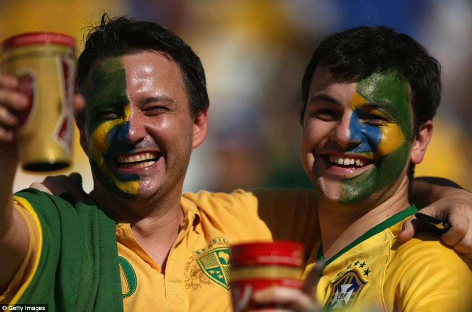 Brazil fans enjoy the atmosphere - and a beer - during the opening ceremony of the 2014 FIFA World Cup in Brazil