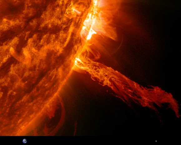 A solar prominence imaged on May 27, 2014. Earth and Moon are shown to scale at the bottom. (NASA/SDO)
