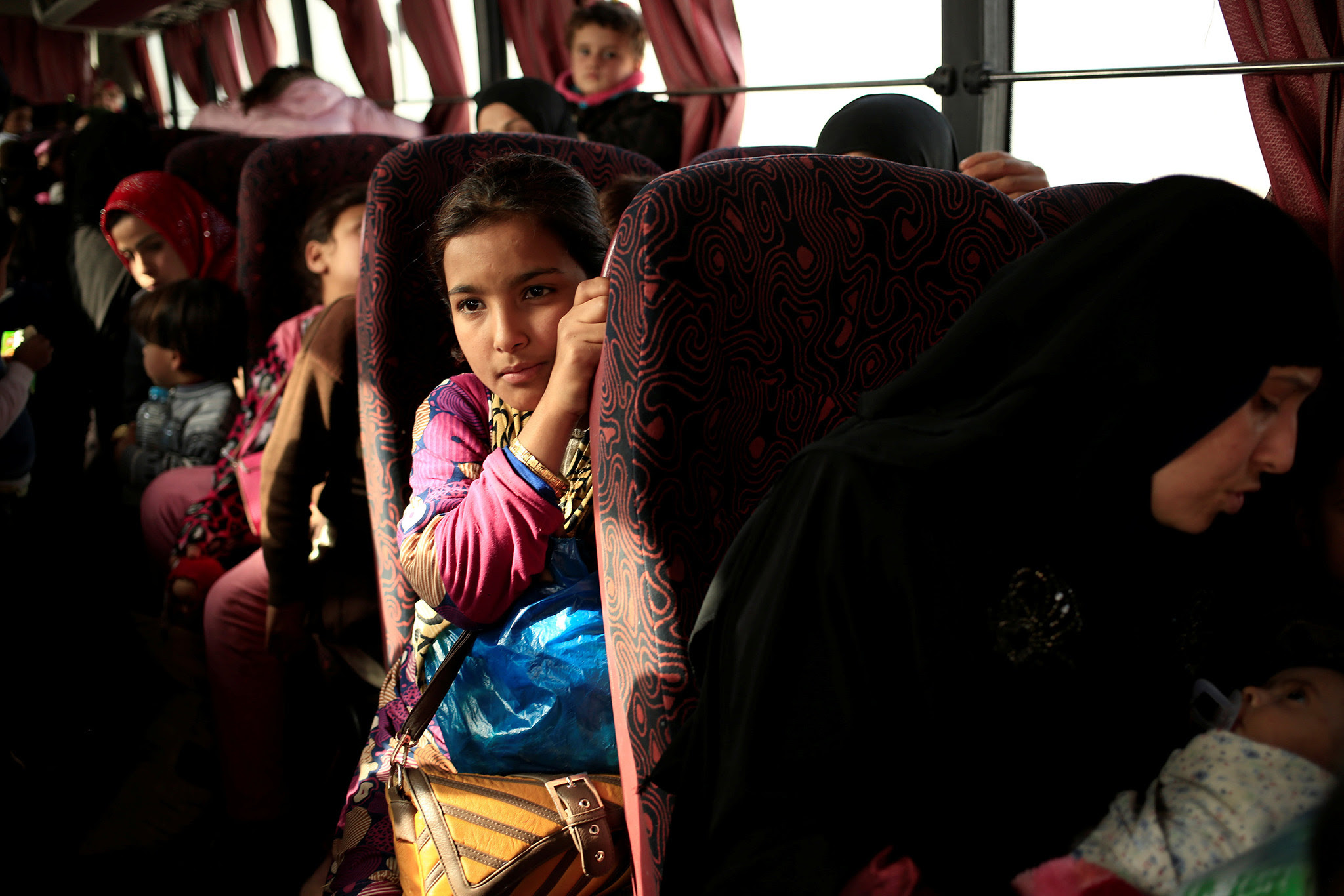 A girl who is fleeing the fighting between Islamic State and the Iraqi army in Mosul sits inside a bus at a Peshmerga checkpoint in Iraq November 14, 2016. REUTERS/Zohra Bensemra