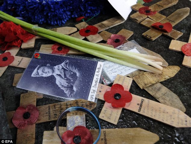 Crosses bearing a poppy at a war memorial in Hyde Park in London today as the government revealed plans to commemorate the centenary of the start of the First World War 