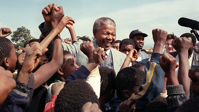 ANC president Nelson Mandela is surrounded by young supporters after addressing residents at Phola Park, a squatter settlement east of Johannesburg, 31 May 1992. (AFP Photo / Walter Dhladhla)