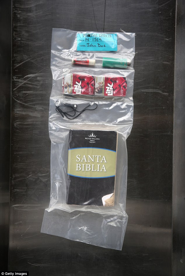 Belongings: Each year, the Pima County Medical Examiner's Office receives about 176 remains recovered from the desert, most of which belong to undocumented immigrants who died of dehydration trying to cross into the U.S. Above, a bible, chapstick and lighter found on a body discovered June 19, 2014 