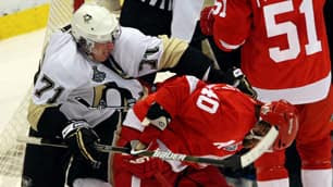 Pittsburgh's Evgeni Malkin, left, takes a shot at Henrik Zetterberg late in Game 2.