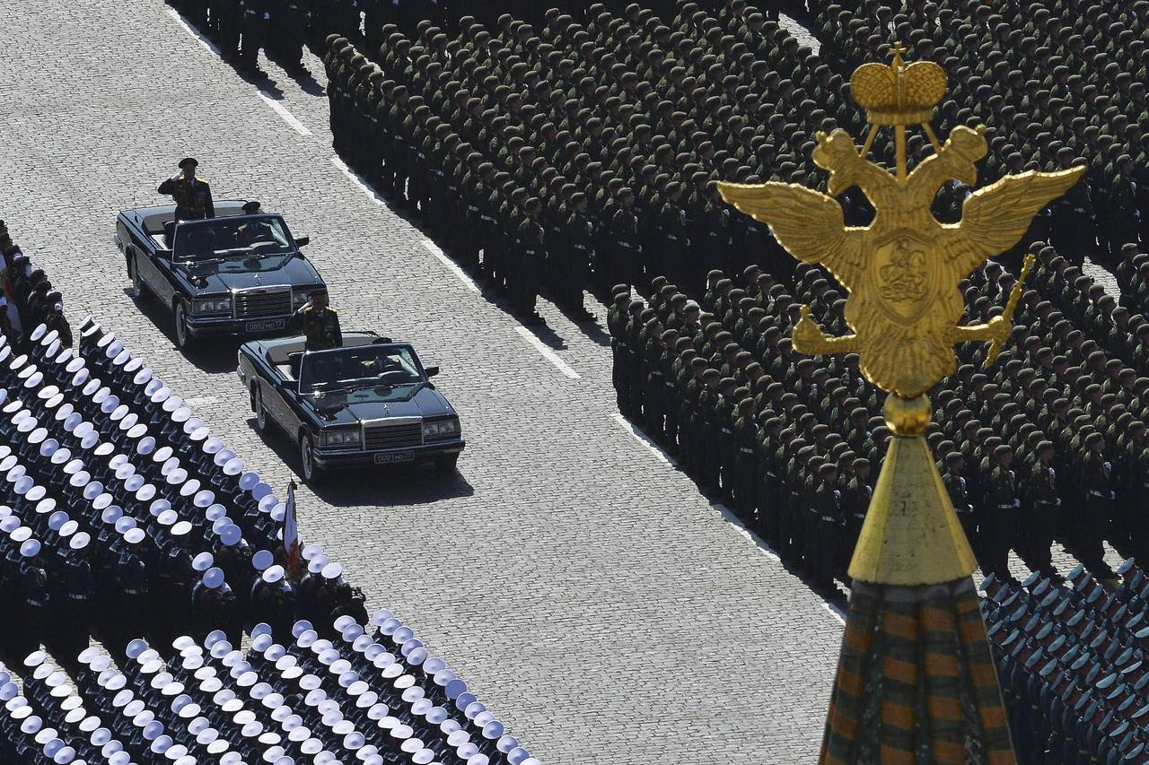 Russian Defense Minister Sergei Shoigu, standing in the leading car, and Colonel-General Oleg Salyukov, behind, review troops at the beginning of the parade.