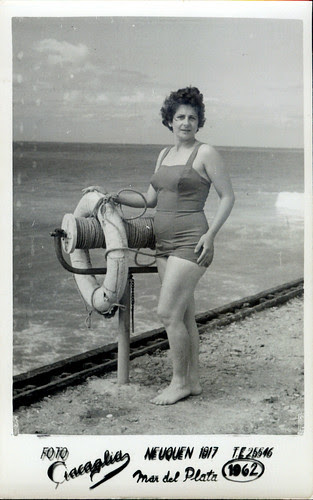 By the sea - girl dark suit standing