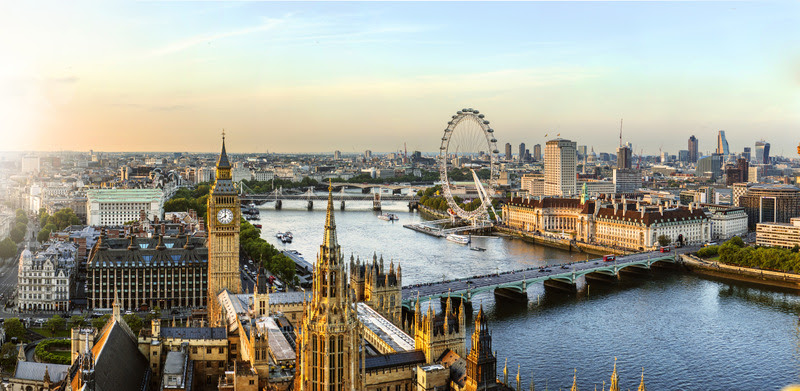 The view from Victoria Tower of the Houses of Parliament, the River Thames, Westminster and Westminster Bridge, to the Millennium Wheel and other landmarks in the evening as the light fades.