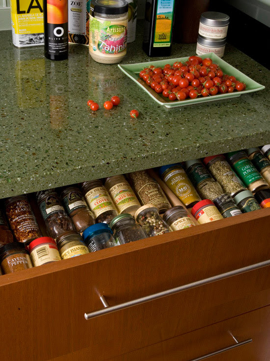 Spice bottles in a shallow drawer