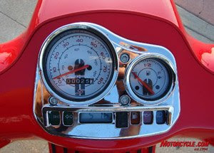 Speedo, fuel gage, clock, and warning lights all packed into a busy, chromy, cluster.