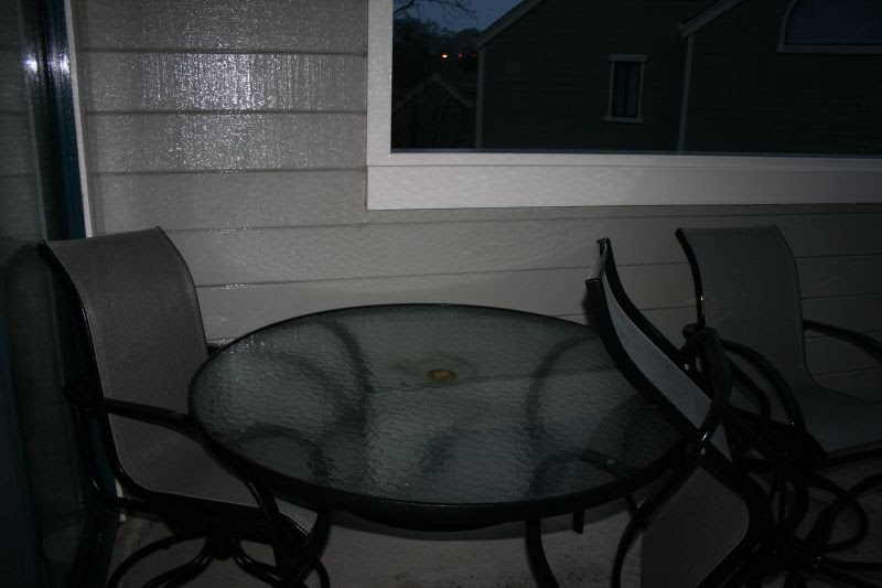 Deck furniture blown against the glass doors