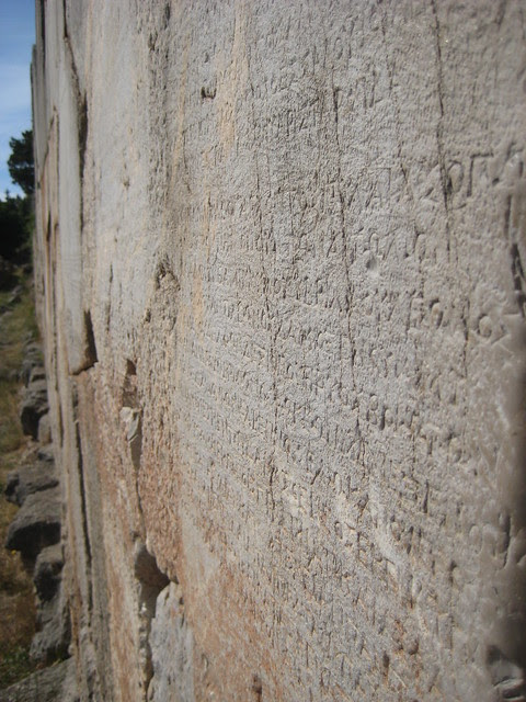 Detailed engraving on the walls at Delphi