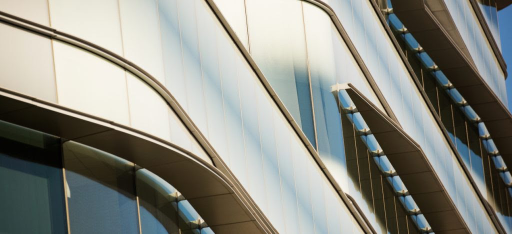 An abstract look at an urban building. Downtown urban skyscraper angles with metal, concrete and steel. Commercial business center with office windows and corporate headquarters.