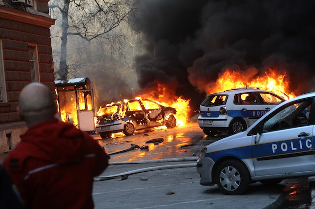 UNREST IN SARAJEVO. People watch police vehicles set ablaze during a demonstration in Sarajevo, Bosnia-Herzegovina, 07 February 2014. Dzenan Krijestorac/EPA