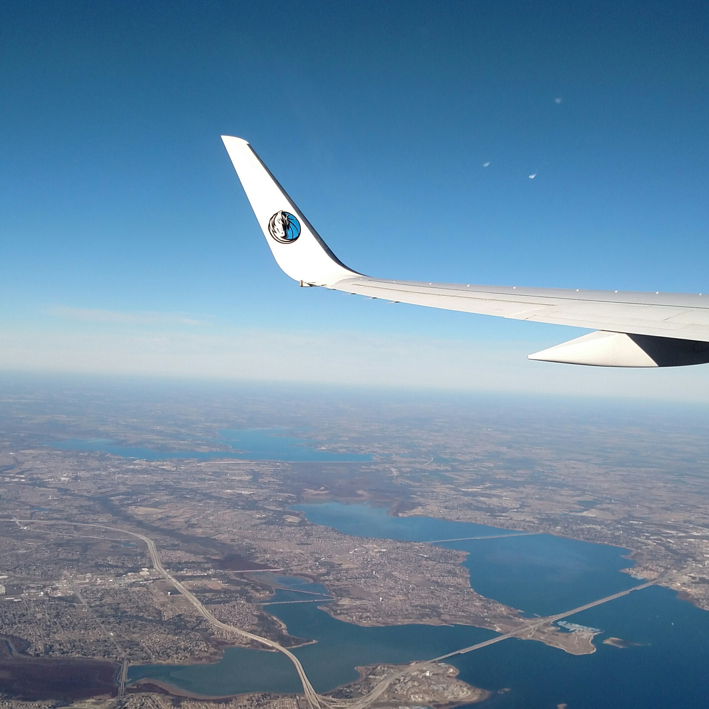 The plane I'm on right now has a Dallas Mavericks logo on ...