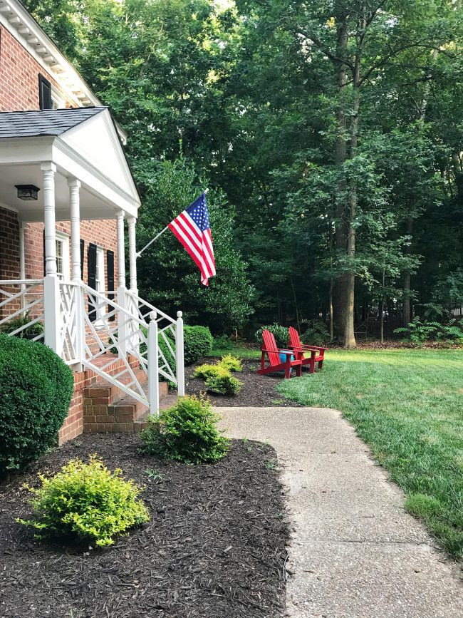 patriotic front porch with american flag red chairs blue ottoman