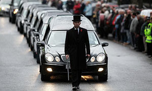 Hearses carrying the coffins of six dead soldiers pass mourners in Wootton Bassett