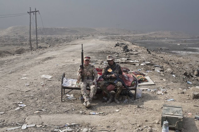 Iraqi army soldiers rest at a checkpoint in Qayara some 50 kilometers south of Mosul Iraq Wednesday Oct. 26 2016. Islamic State militants have been goin
