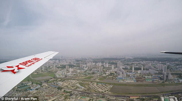 Footage shows colourful buildings and skyscrapers as well as modern highways, overpasses and bridges