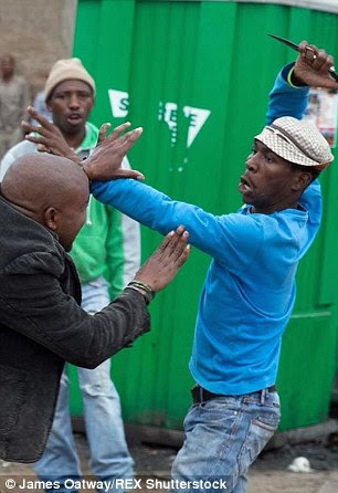 Shocking images capture the moment the armed gang surround Emmanuel Sithole and repeatedly stab him with knives and bludgeon him with a wrench in Alexandra township near Johannesburg