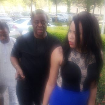 Chief Fani-Kayode (in black) walks behind his wife, Precious Chikwendu at the premises of the federal high court in Abuja