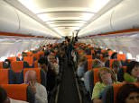 Interior of Easy Jet easyjet plane airplane with passengers seated.