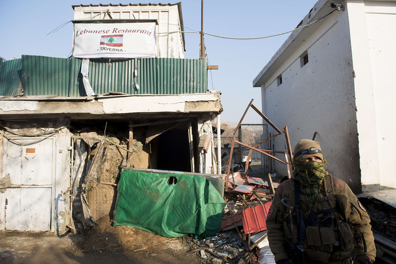 Description of  An Afghan special force soldier stands guard next to the damaged entrance of a Lebanese restaurant that was attacked in Kabul, on January 18, 2014.  At least 14 people were killed, including foreigners, in a multiple Taliban suicide attack on a popular restaurant in Kabul on January 17, officials said, with two gunmen launching an "indiscriminate" killing spree inside the venue. JOHANNES EISELE/AFP/Getty Images