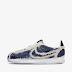 Upside Down Nike Sign Shoes - The nike logo appears in yellow over white on the left shoe and is then flipped upside down over a purple patch on the left.