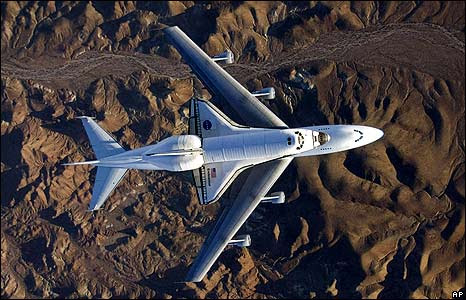 The space shuttle Endeavour, mounted on top of a modified Boeing 747 carrier aircraft, flies over California's Mojave Desert