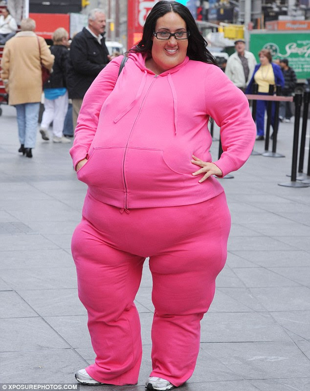 Plus size: Real Housewives star Melissa Gorga sports a bright pink tracksuit over a fat suit as she stepped out in New York today, filming a segment for Entertainment Tonight