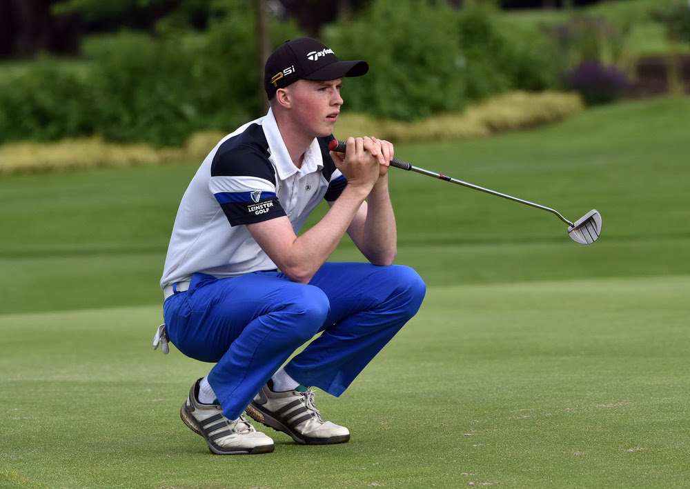Mark Power (Kilkenny) lining up his putt on the 18th green during the second round of the 2016 Irish Boys Amateur Open Championship at Castle Golf Club. Picture by Pat Cashman