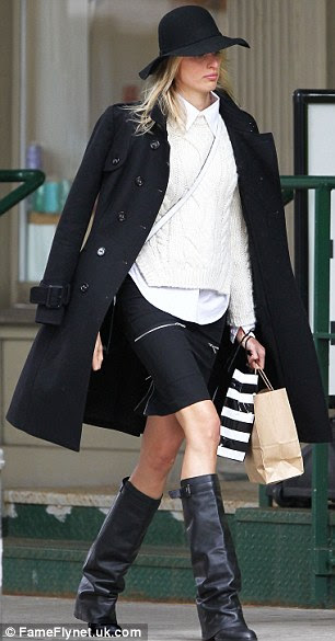 Caped catwalk favourite: The star also wrapped her frame in black coat
