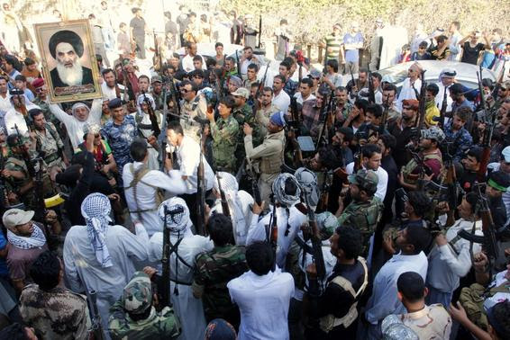 Volunteers, who have joined the Iraqi Army to fight against the predominantly Sunni militants from the radical Islamic State of Iraq and the Levant (ISIL), gather with their weapons during a parade on the streets in Basra, southeast of Baghdad, June 16, 2014. REUTERS-Essam Al-Sudani