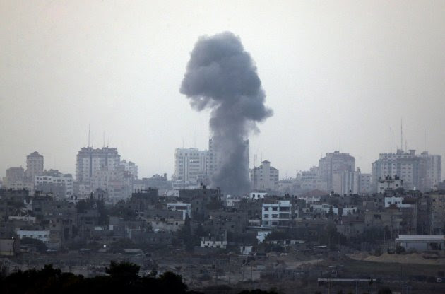 A plume of smoke is seen over central Gaza Strip, after an airstrike by Israeli forces, as seen from the Israel Gaza border, Monday, Nov. 19, 2012. Israeli aircraft struck crowded areas in the Gaza Strip and killed a senior militant with a missile strike on a media center Monday, driving up the Palestinian death toll to 96, as Israel broadened its targets in the 6-day-old offensive meant to quell Hamas rocket fire on Israel. (AP Photo/Lefteris Pitarakis)