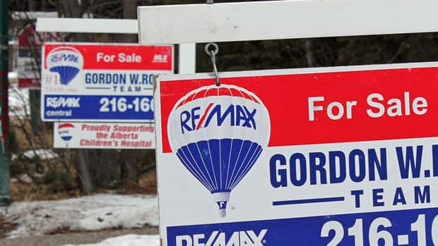 For sale signs shown in Calgary in March. The Royal Bank hiked five-year mortgage rates Monday. 