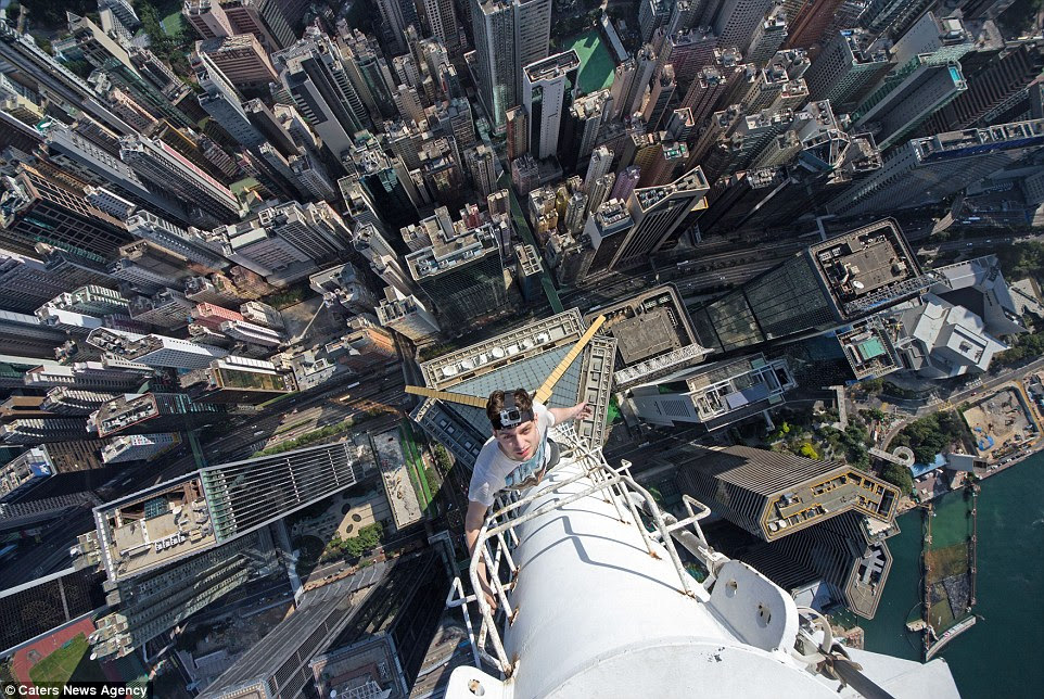 Preparation: Ivan Kuznetsov says the main attributes to have when 'rooftopping' are courage, ingenuity, and intuition. In this photograph he is seen looking calm while scaling the outside of a building in Shanghai, China