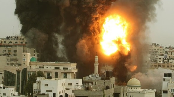 An explosion and smoke are seen after Israeli strikes in Gaza City November 17, 2012.
