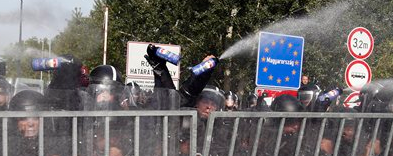 Hungarian police spray rioting Muslims with water cannons and tear gas Wednesday.