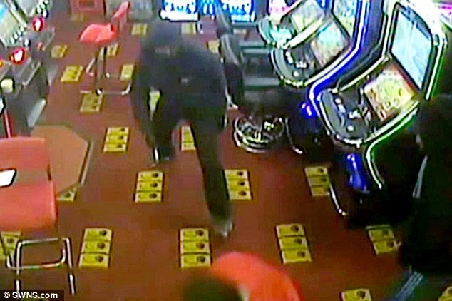 The worker is confronted by a knife-wielding masked raider as the gang demand money from the arcade