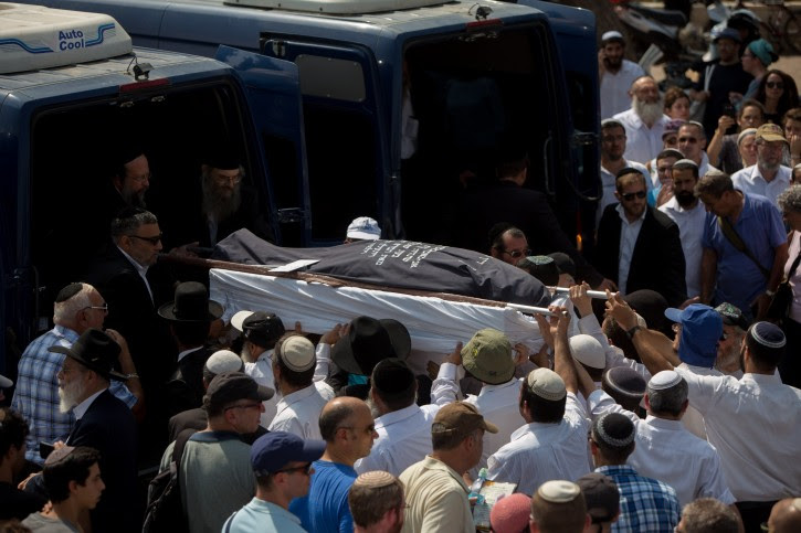 Friends and family carry the bodies of Israeli couple, Naama and Eitam Henkin during their funeral at Har HaMenuchot Cemetery in Jerusalem on Friday, October 2, 2015, Israeli couple, Naama and Eitam Henkin, were shot dead last night while driving by the West Bank settlement of Itamar. Four of the couple's six children were in the car at the time, but were unhurt. Photo by Yonatan Sindel/Flash90