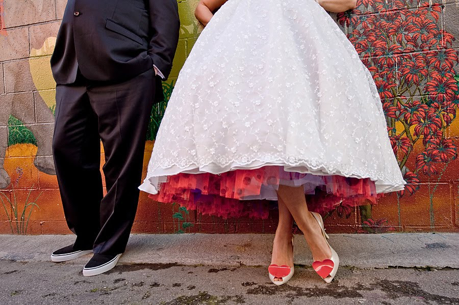 Bride wears tealength white wedding dress with red purple polka dot tulle 