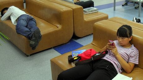 Young people on campus using smartphones and sleeping