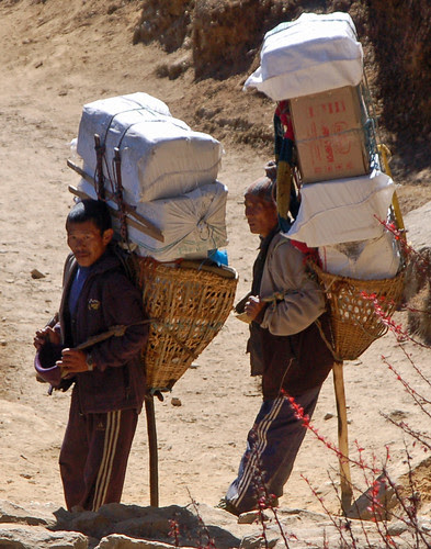 10loaded porters leaning on wood staffs.jpg