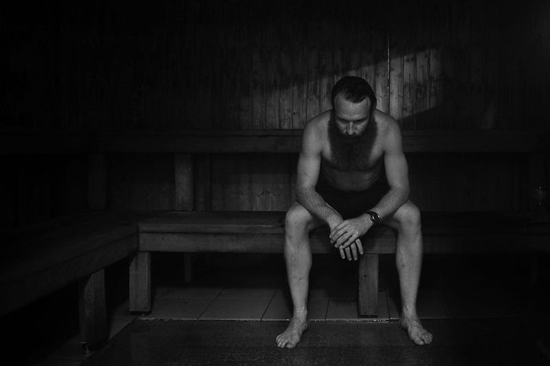 a man sitting in a sauna