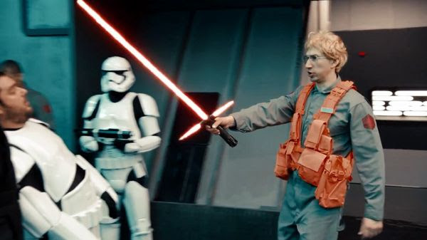 Matt, the radar technician shows off Kylo Ren's lightsaber to fellow First Order personnel in UNDERCOVER BOSS: STARKILLER BASE.