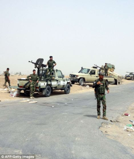 Kurdish Iraqi Peshmerga forces deploy their troops and armoured vehicles on the outskirts of the multi-ethnic city of Kirkuk