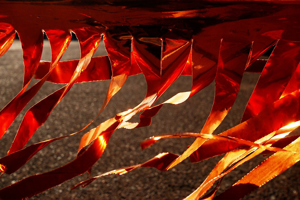 Bright orange ribbons flickering in the wind.